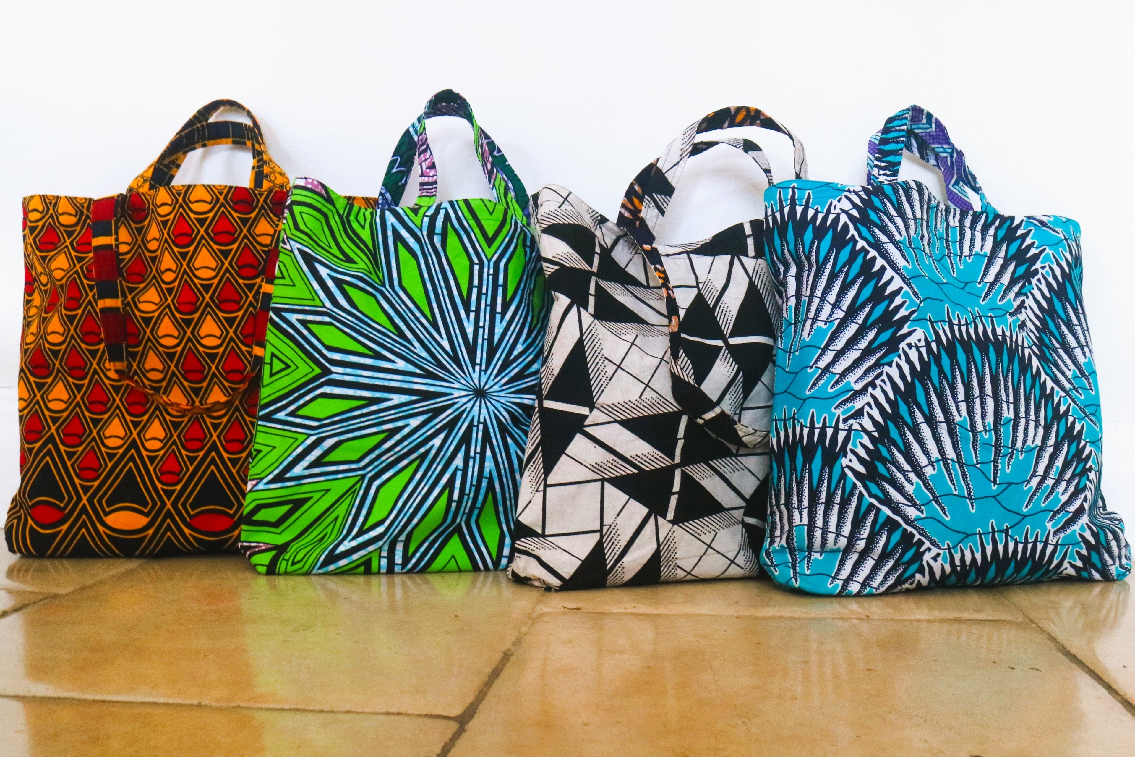 Five patterned bags on a tiled floor